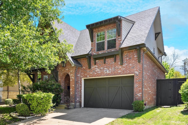view of front of home featuring brick siding, an attached garage, driveway, and roof with shingles