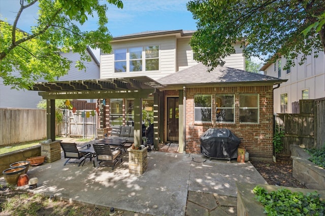 rear view of house with a pergola, a fenced backyard, a patio, brick siding, and roof with shingles