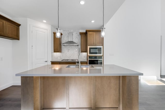 kitchen with tasteful backsplash, recessed lighting, stainless steel appliances, wall chimney range hood, and a sink