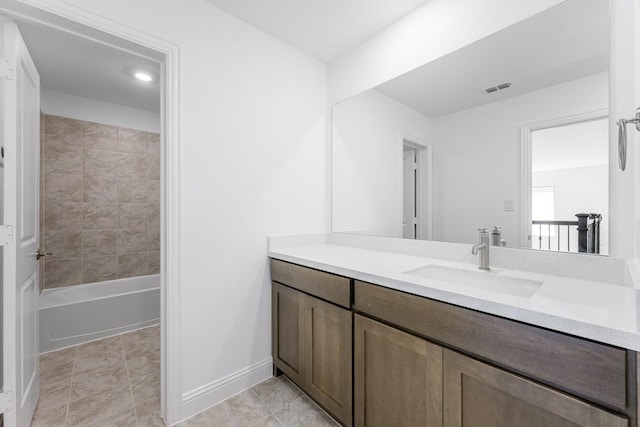 bathroom featuring baseboards, visible vents, bathtub / shower combination, and vanity