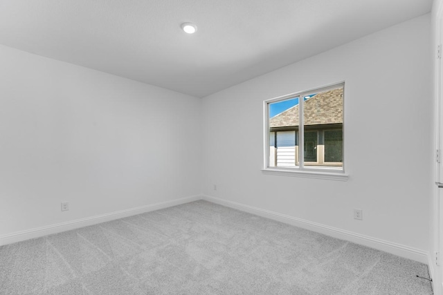 spare room with carpet flooring and baseboards