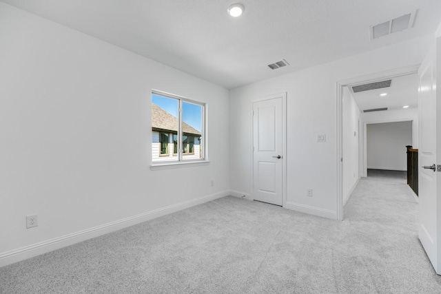 unfurnished bedroom with recessed lighting, visible vents, light carpet, and baseboards