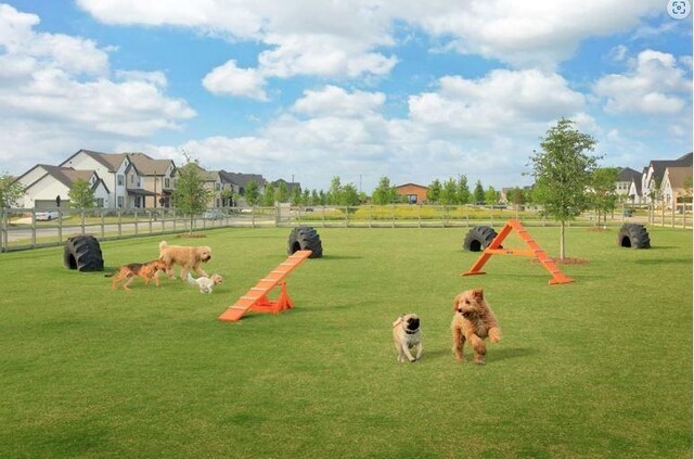 surrounding community with fence and a residential view