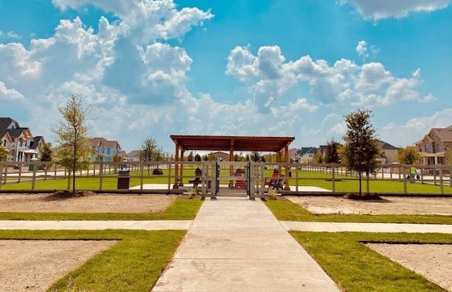 surrounding community featuring a residential view, a lawn, and fence