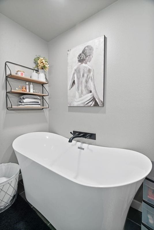 full bath featuring tile patterned floors and a soaking tub