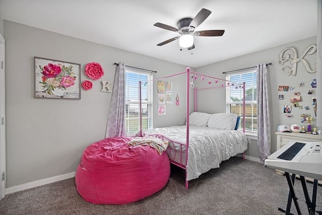 carpeted bedroom with multiple windows, baseboards, and a ceiling fan