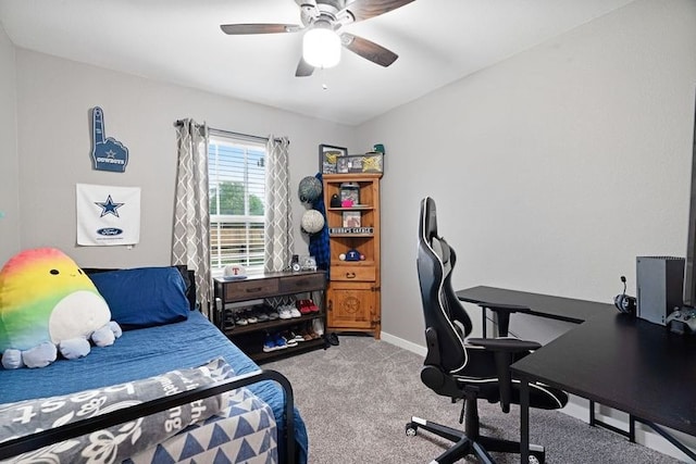 carpeted bedroom featuring baseboards and a ceiling fan