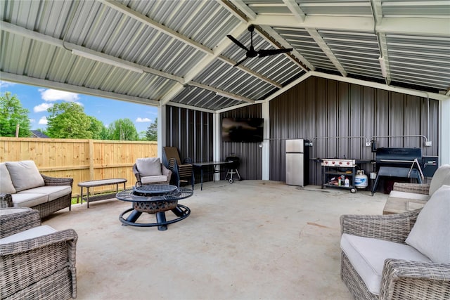 view of patio with an outdoor living space with a fire pit and an outdoor structure