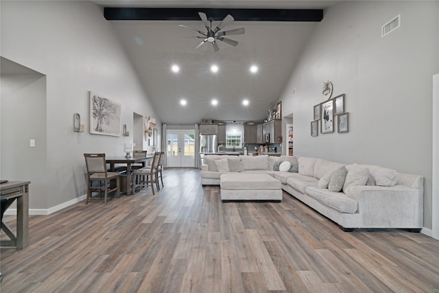 living room featuring visible vents, beam ceiling, ceiling fan, high vaulted ceiling, and wood finished floors