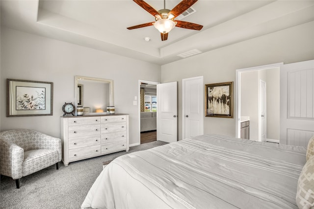 5045 Cervinae Rd, Fort Worth, TX 76036 - carpeted bedroom with a raised ceiling, ensuite bathroom, ceiling fan, and baseboards