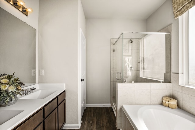 5045 Cervinae Rd, Fort Worth, TX 76036 - bathroom with wood finished floors, a shower stall, a bath, and double vanity