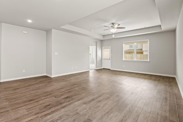 5045 Cervinae Rd, Fort Worth, TX 76036 - unfurnished living room featuring a tray ceiling, a ceiling fan, dark wood-style flooring, baseboards, and recessed lighting