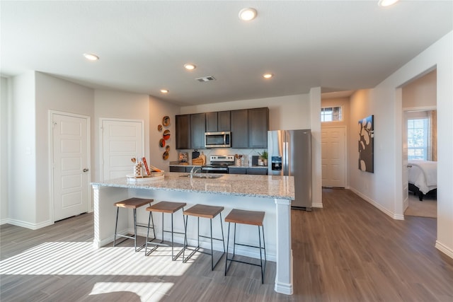 5045 Cervinae Rd, Fort Worth, TX 76036 - kitchen featuring stainless steel appliances, light wood finished floors, baseboards, recessed lighting, and a breakfast bar area