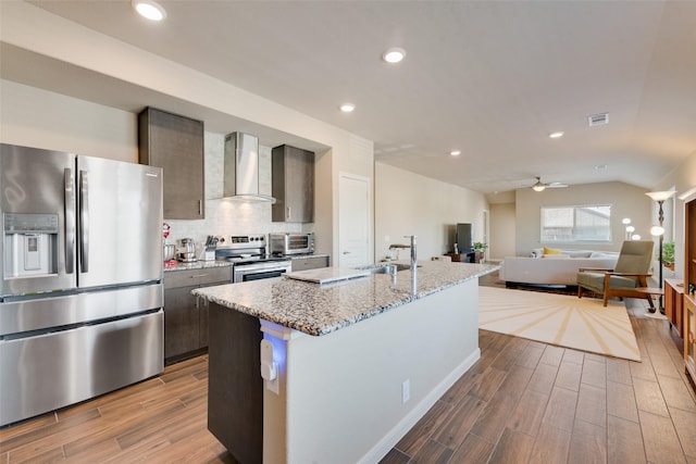 754 Brookline Dr, Lavon, TX 75166 - kitchen with stainless steel appliances, wall chimney range hood, a sink, dark wood finished floors, and a ceiling fan