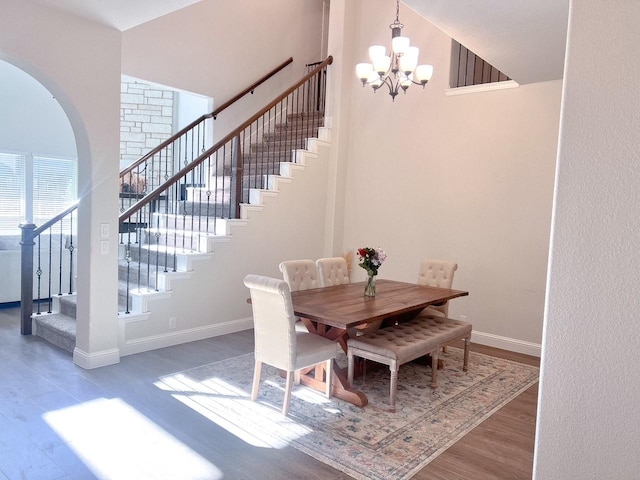 206 Lakewood Ln, Ponder, TX 76259 - dining room featuring wood finished floors, stairway, a chandelier, and baseboards