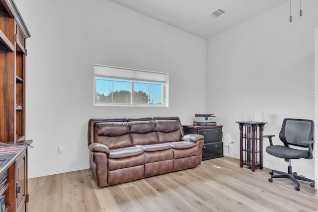 office space with light wood-style flooring, baseboards, and visible vents