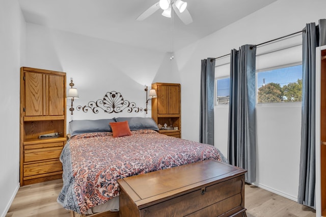 bedroom featuring baseboards, light wood-type flooring, and a ceiling fan