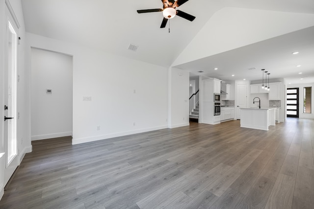 1538 Ginger Ln, Argyle, TX 76226 - unfurnished living room with a ceiling fan, stairway, a sink, light wood-style floors, and recessed lighting
