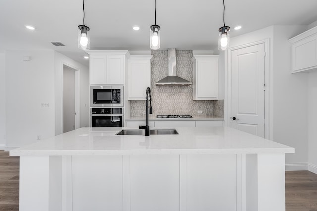 1538 Ginger Ln, Argyle, TX 76226 - kitchen with appliances with stainless steel finishes, wall chimney range hood, a sink, baseboards, and dark wood-style flooring