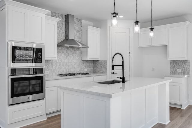 1538 Ginger Ln, Argyle, TX 76226 - kitchen featuring stainless steel oven, wall chimney range hood, a sink, decorative backsplash, and wood finished floors