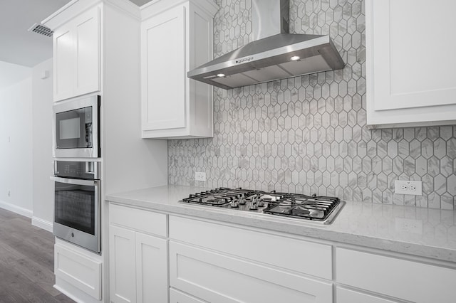 1538 Ginger Ln, Argyle, TX 76226 - kitchen featuring stainless steel appliances, wall chimney range hood, tasteful backsplash, and white cabinets
