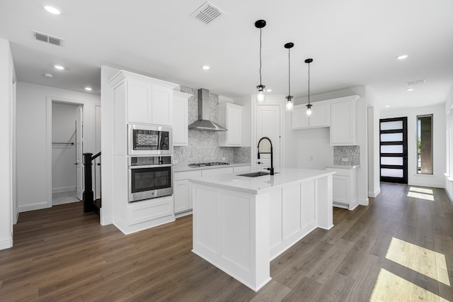 1538 Ginger Ln, Argyle, TX 76226 - kitchen featuring appliances with stainless steel finishes, wall chimney range hood, a sink, backsplash, and dark wood-style flooring
