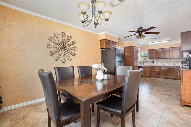 1128 Mason Dr, Hurst, TX 76053 - dining space featuring visible vents, a textured ceiling, baseboards, and ceiling fan with notable chandelier