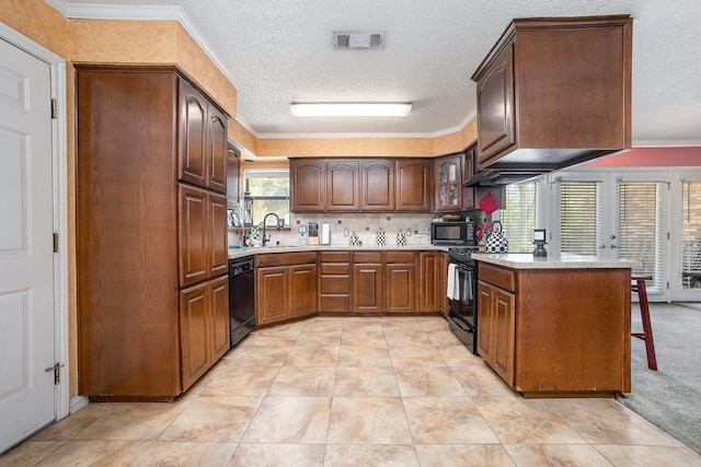 1128 Mason Dr, Hurst, TX 76053 - kitchen with ornamental molding, visible vents, light countertops, and black appliances