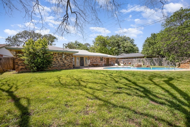 1128 Mason Dr, Hurst, TX 76053 - back of property with a fenced in pool, brick siding, fence, and a lawn