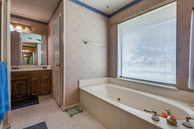 9A Rhea Mills Cir, Prosper, TX 75078 - bathroom featuring tile patterned floors, a garden tub, vanity, a textured ceiling, and wallpapered walls