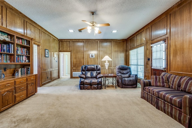 9A Rhea Mills Cir, Prosper, TX 75078 - living room with light colored carpet, wooden walls, ceiling fan, and a textured ceiling