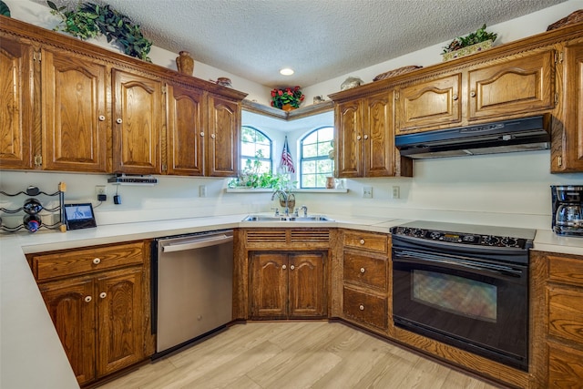 9A Rhea Mills Cir, Prosper, TX 75078 - kitchen with black electric range, stainless steel dishwasher, range hood, a sink, and a textured ceiling