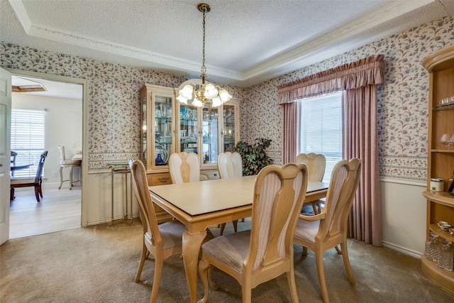 9A Rhea Mills Cir, Prosper, TX 75078 - dining area featuring wallpapered walls, a chandelier, a textured ceiling, a raised ceiling, and ornamental molding