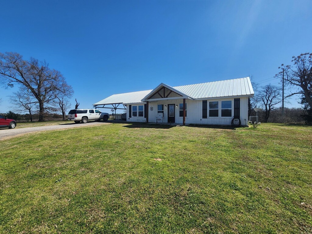 407 County Road 3204, Quitman, TX 75783 - single story home featuring metal roof, a front yard, and driveway