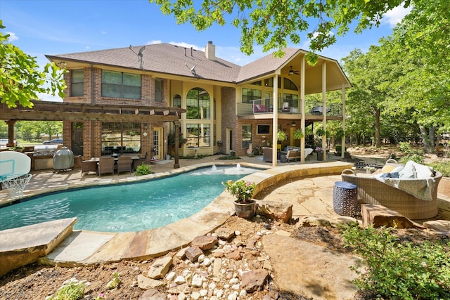 3604 Post Oak Trl, Corinth, TX 76210 - rear view of property with an outdoor kitchen, a balcony, outdoor lounge area, brick siding, and a patio area