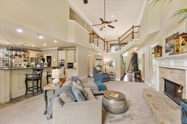 3604 Post Oak Trl, Corinth, TX 76210 - living area with a high ceiling, a fireplace, a ceiling fan, stairs, and baseboards