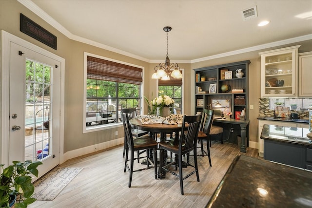 3604 Post Oak Trl, Corinth, TX 76210 - dining space featuring light wood-style flooring, a chandelier, baseboards, and ornamental molding