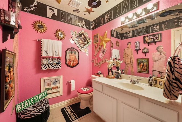 3604 Post Oak Trl, Corinth, TX 76210 - half bathroom with tile patterned floors, toilet, vanity, and baseboards