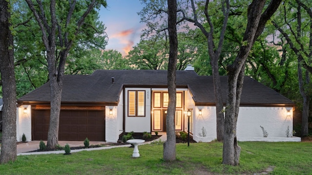 2204 Wood Cliff Ct, Arlington, TX 76012 - view of front of house with brick siding, a garage, a front lawn, and concrete driveway