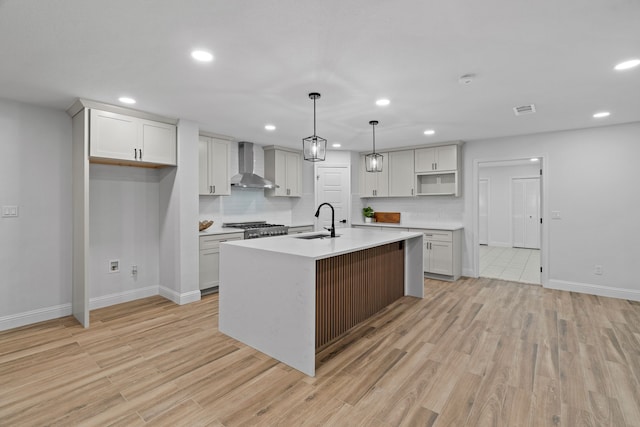2204 Wood Cliff Ct, Arlington, TX 76012 - kitchen featuring wall chimney range hood, a sink, baseboards, recessed lighting, and light wood-style floors
