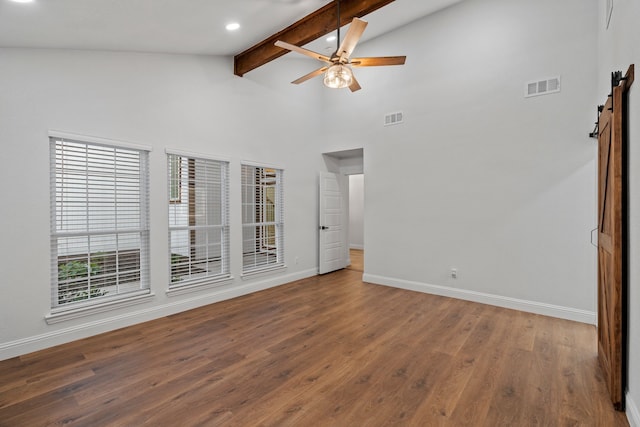 empty room featuring beam ceiling, visible vents, and baseboards
