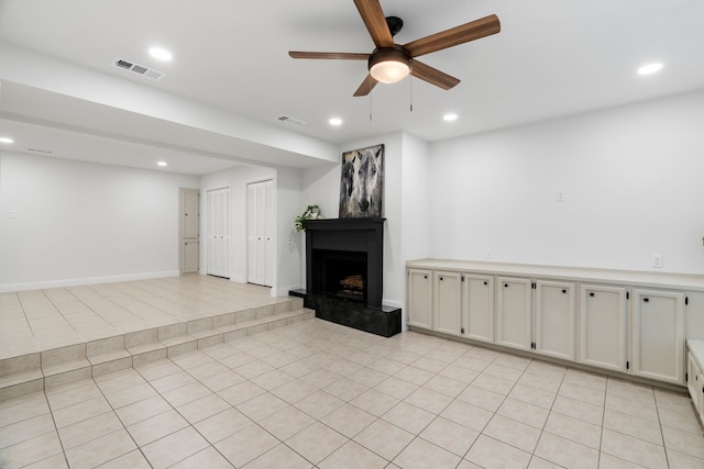 unfurnished living room featuring light tile patterned flooring, recessed lighting, a ceiling fan, and visible vents