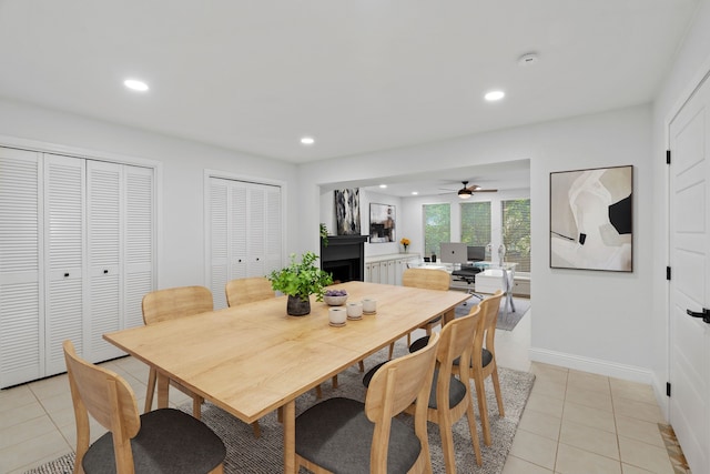 dining space featuring recessed lighting, a fireplace, light tile patterned floors, ceiling fan, and baseboards