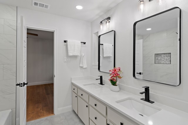 2204 Wood Cliff Ct, Arlington, TX 76012 - bathroom with double vanity, baseboards, and recessed lighting