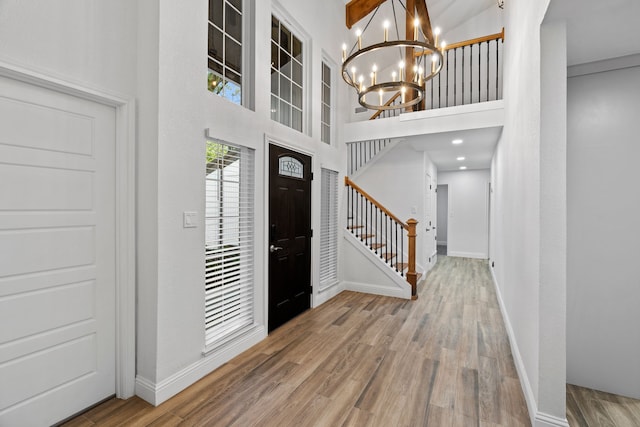2204 Wood Cliff Ct, Arlington, TX 76012 - foyer with a chandelier, stairway, wood finished floors, a towering ceiling, and baseboards