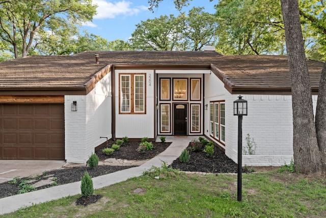 view of front of property with brick siding and a garage