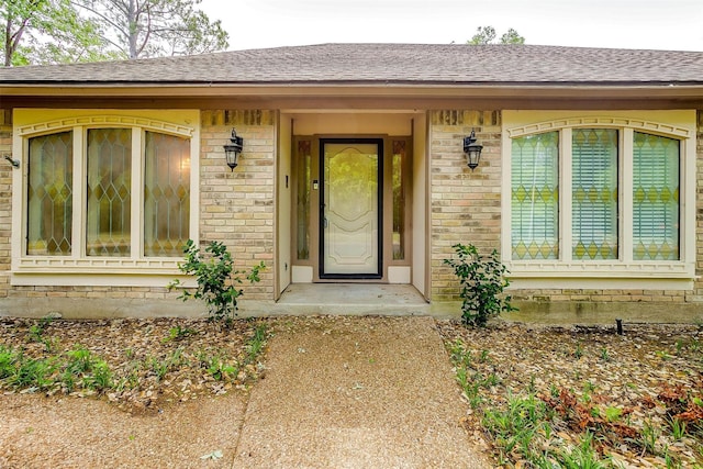 6809 River Bend Rd, Fort Worth, TX 76132 - doorway to property featuring brick siding and a shingled roof