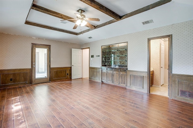 6809 River Bend Rd, Fort Worth, TX 76132 - unfurnished living room with wood-type flooring, a ceiling fan, visible vents, and a wainscoted wall