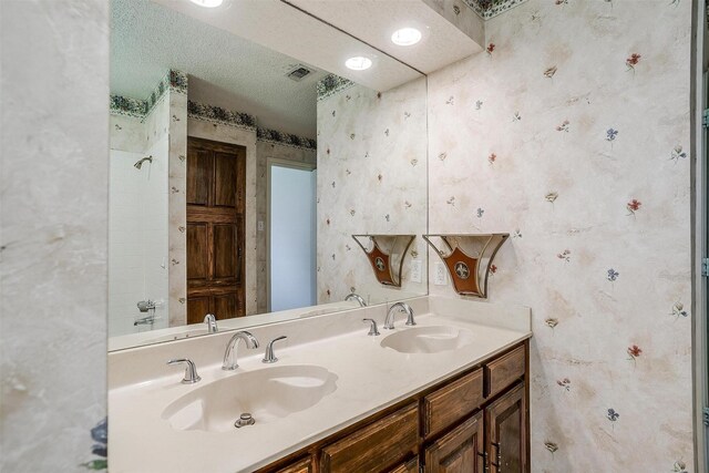 6809 River Bend Rd, Fort Worth, TX 76132 - full bathroom with double vanity, a sink, visible vents, and wallpapered walls