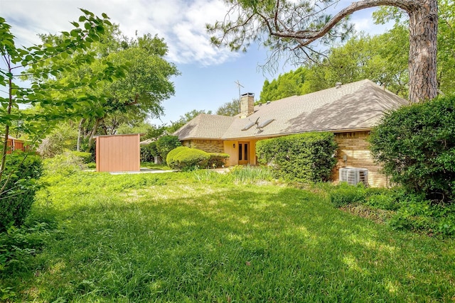 6809 River Bend Rd, Fort Worth, TX 76132 - view of yard featuring central air condition unit and an outbuilding